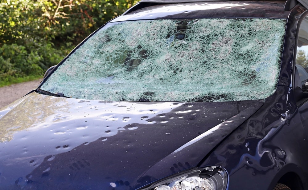 car hood and window with hail damage